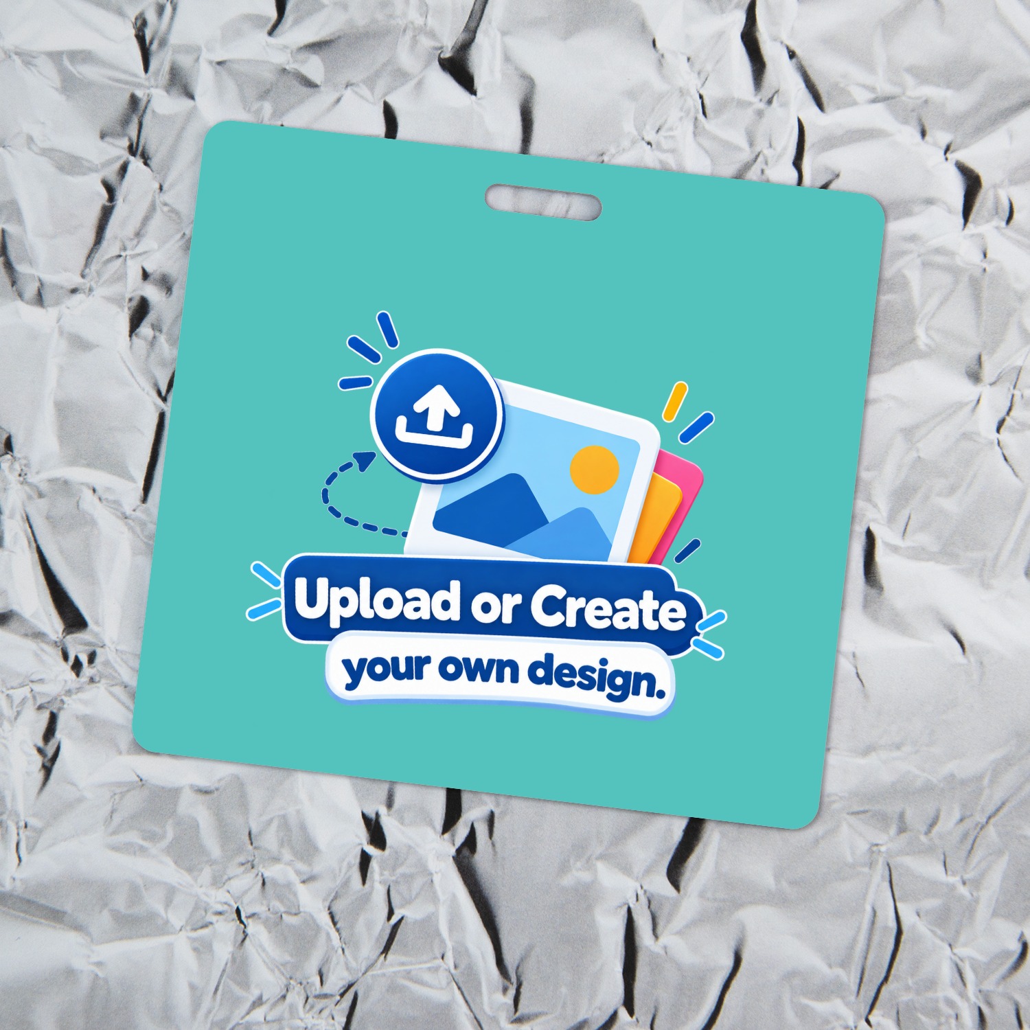Teal horizontal ID badge with Upload or Create your own design graphic lying on crinkled aluminum foil