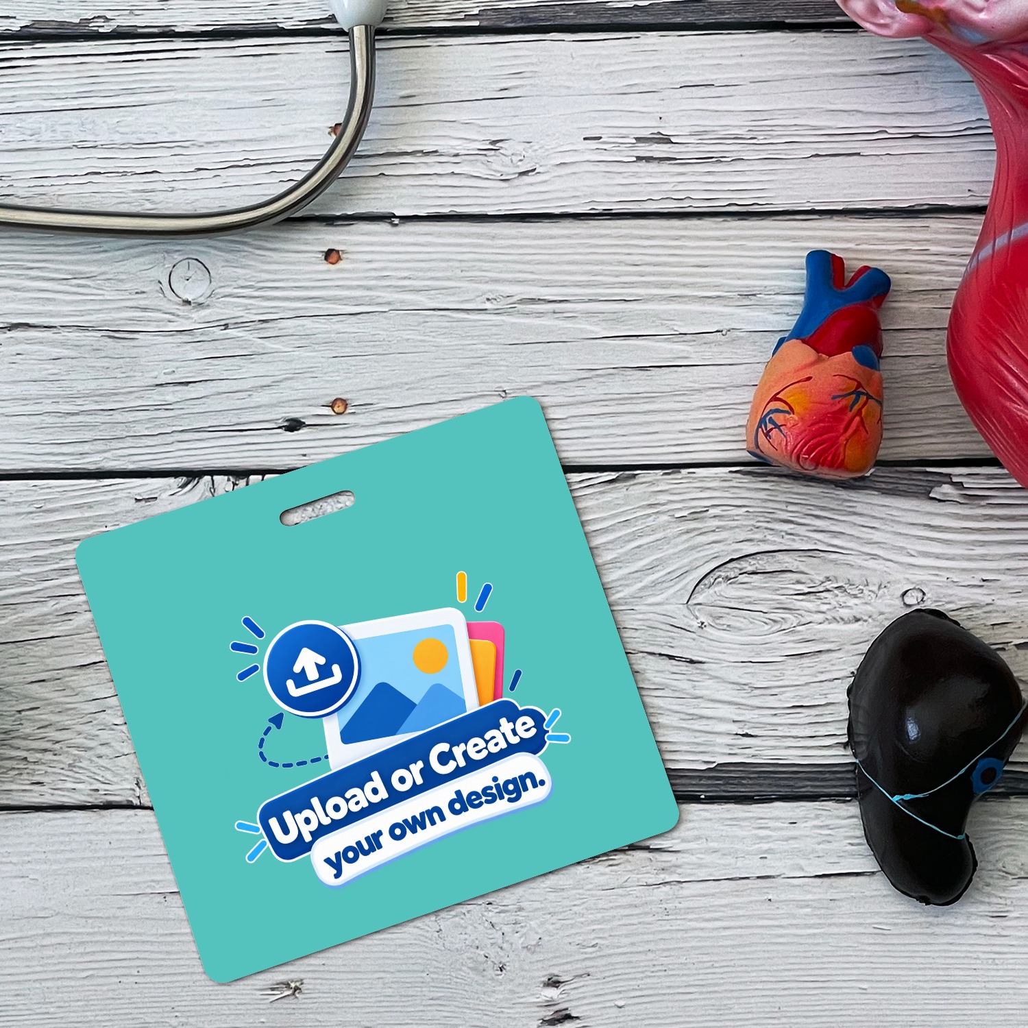 Teal horizontal ID badge with Upload or Create your own design graphic beside anatomical heart model and stethoscope