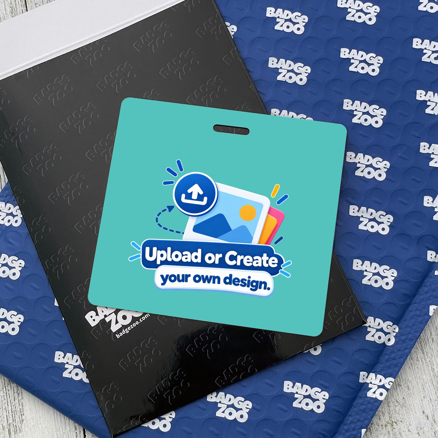 Teal horizontal ID badge with Upload or Create your own design graphic on black folder beside blue Badge Zoo mailer