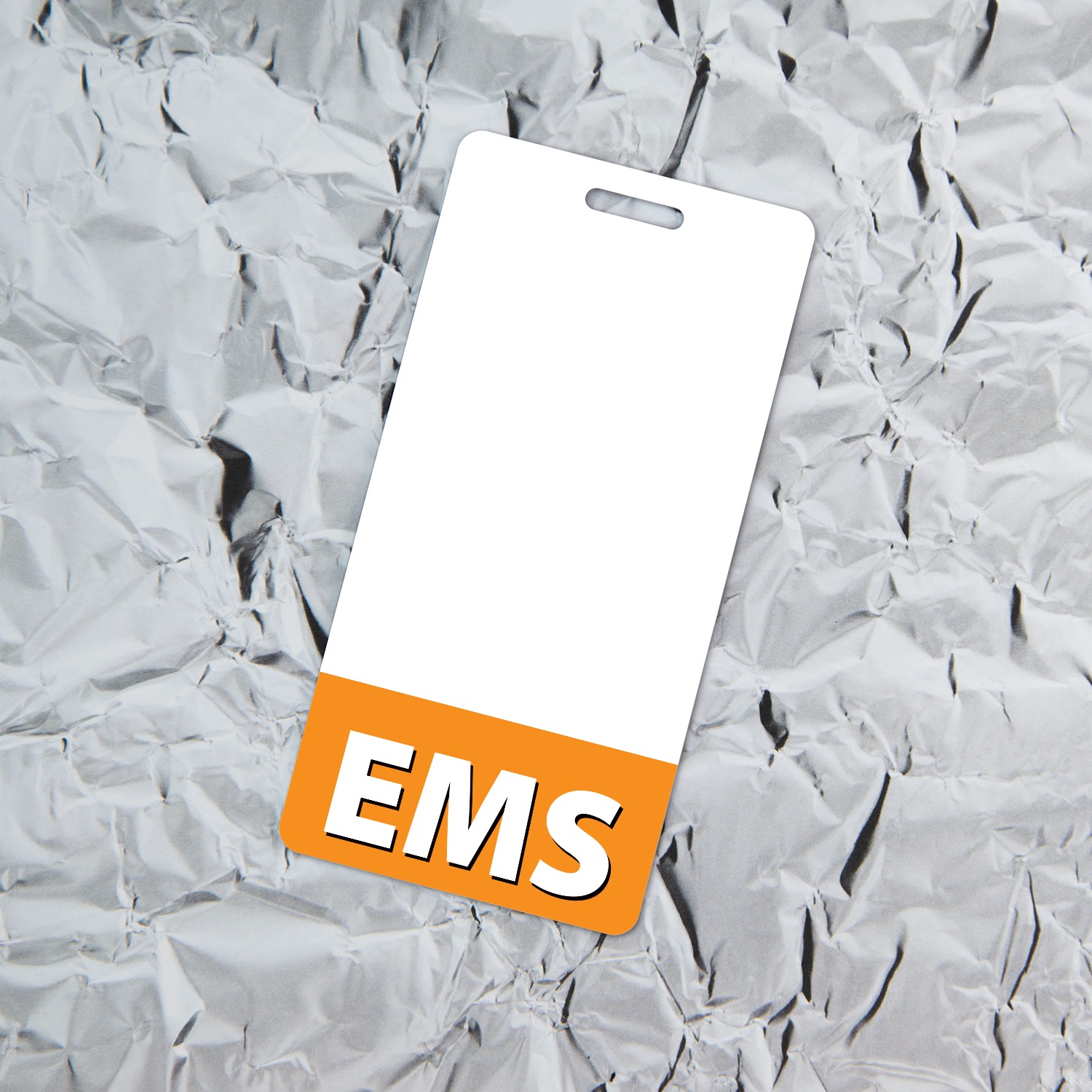 Vertical white EMS badge holder with orange bottom band tilted on crinkled silver aluminum foil background