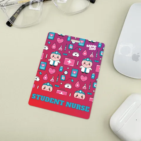 Multicolor student nurse badge buddy with cute nurse icons on a light table beside clear glasses and a white computer mouse