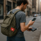 Man walking in the city wearing a backpack with a red medical ID patch featuring a white asterisk symbol